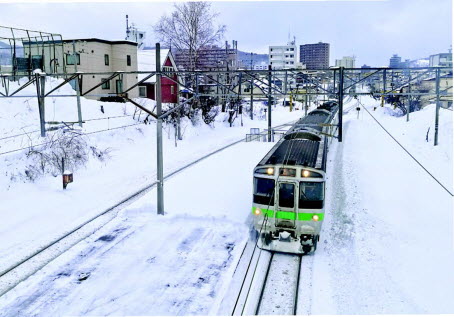 눈 덮인 선로를 달리는 일본 철도 차량